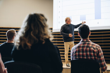 Senior businessman giving presentation in a summit