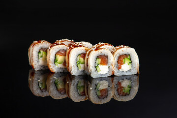 salmon sushi roll on black