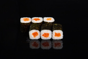 salmon rolls on black