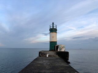 calm sea with beautiful sunset sky and lighthouse