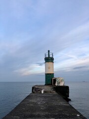 calm sea with beautiful sunset sky and lighthouse