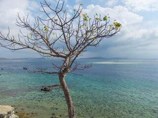 Stunning view, crystal clear blue water and white sand beach at Pulo Mesah Island Flores Indonesia