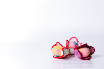 Happy easter, Easter painted eggs in the knitted flowers on white background for your decoration in holiday. Copy space.