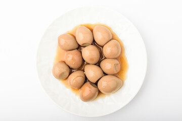 Stewed quail eggs on a white background