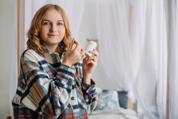 Close up image of blonde woman putting white round pill in mouth. Sick female taking medicines, antidepressant, painkiller or antibiotic. Lifestyle. Headache concept, Mockup packaging