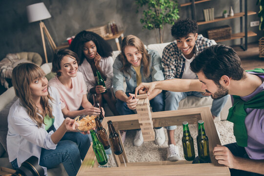 Photo portrait of students company playing genga game challenge excited drinking beer