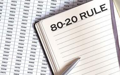 Obraz premium Business concept, on the table a notepad with the text of the 80- 20 rule , profit, loss and graph