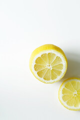 half of fresh lemon and lemon slice on white background