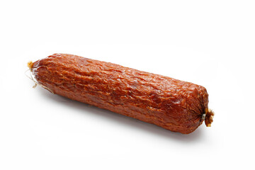 Traditional dry smoked sausage isolated on a white background. Whole krakowska sausage.