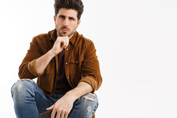 Obraz premium Masculine handsome man posing with mobile phone