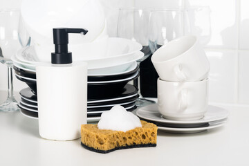 dish detergent and sponge on the counter next to the plates