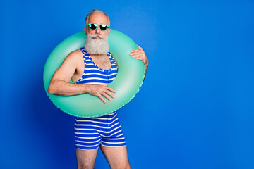 Photo of optimistic grey beard man wear lifebuoy eyewear blue swimsuit isolated on blue background