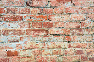 Brick texture close-up. Brick wall made of red bricks. Old masonry. Collapsed wall of a house.