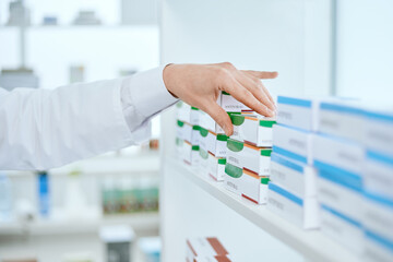 image of a pharmacist taking a box of medicine.
