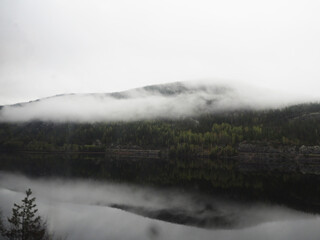 Gloomy landscape with fog on Norwegian fjords