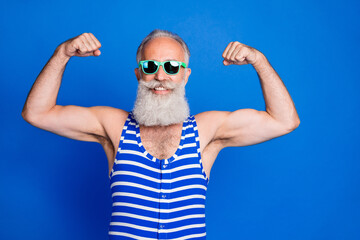 Photo of mature happy cheerful good mod handsome cool man in sunglasses show biceps isolated on...
