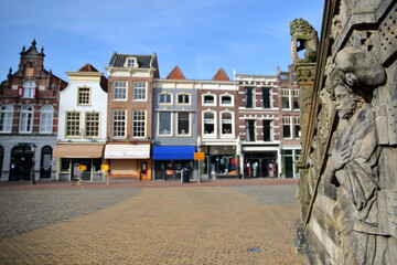 Close-up on statues located at the entrance of the Stadhuis (town hall, dated from 1450), with historic houses in the background, Gouda, South_Holland, Netherlands