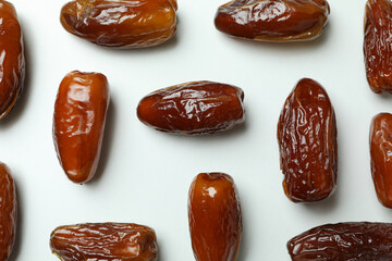 Flat lay with tasty dates on white background