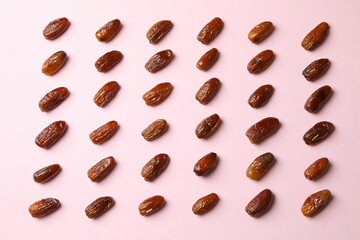 Flat lay with tasty dates on pink background