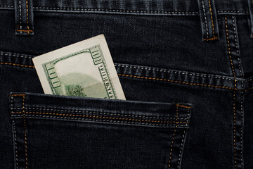 money in your pocket. dollar bills in jeans pocket. The concept of pocket money. Cash. American money, 100 dollar bills. Business, trade or financial transactions, seasonal discounts. close-up