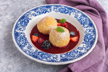 Sweet dumplings with berry sauce and fresh berries
