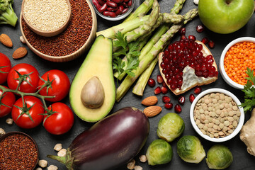 Fresh vegetables, fruits and seeds on black table, flat lay