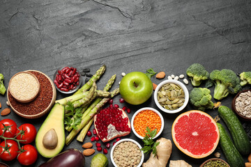 Fresh vegetables, fruits and seeds on black table, flat lay