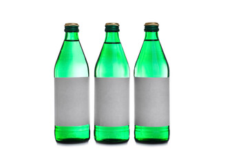 Glass bottles with soda water on white background