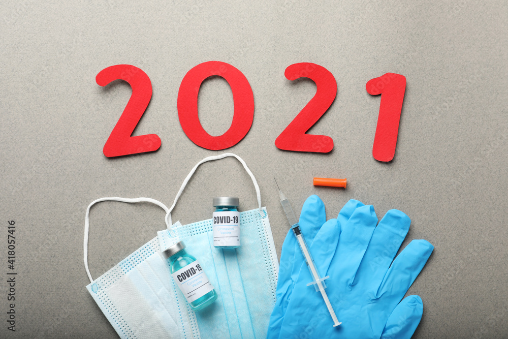 Wall mural Flat lay composition with coronavirus vaccine and number 2021 on grey background