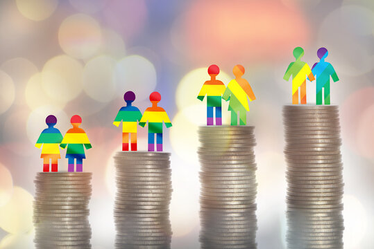 Love is love lGBT lesbian gay bisexual transgender rainbow model on stack of coins on colorful bokeh background. Making money with saving concept and return on investment roi idea