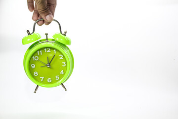 the concept of the hand is holding a bell clock