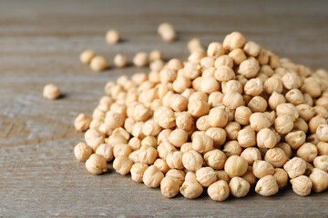 Pile of Chickpeas on wooden table, closeup. Space for text