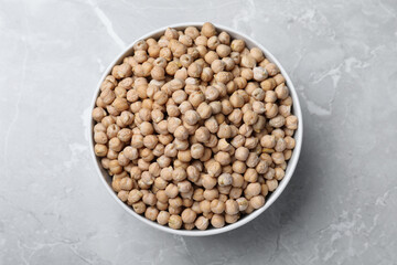 Chickpeas in bowl on light grey table, top view