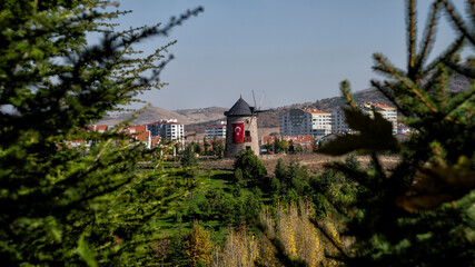 The windmill in the open air museum with the Turkish flag hanging on it  Wind mild in Altinkoy village, Ankara