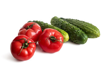 Red tomatoes and green cucumbers on a white background