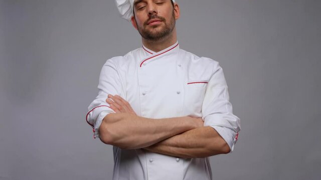 cooking, culinary and people concept - happy smiling male chef in toque and jacket over grey background