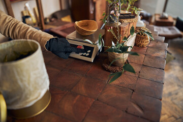 Male worker using electronic scales in tea shop