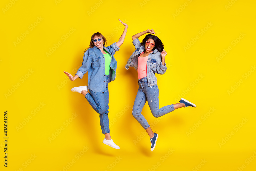 Wall mural Full size portrait of carefree adorable persons have fun toothy smile free time isolated on yellow color background