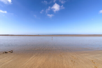 Alone on the beach in Normandy coast. Hauteville-sur-Mer village