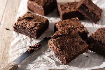 Homemade pieces of brownies on wooden table	