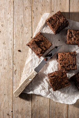 Homemade pieces of brownies on wooden table	