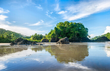 Manuel Antonio beatiful tropical beach with white sand, green palms and blue ocean. Paradise. National Park in Costa Rica, Central America.