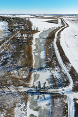 Aerial panoramic view of river Trebel with historic Bascule Bridge near Nehringen (Germany) in winter