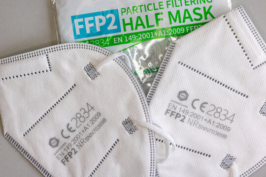 Neckargemund, Germany: March 4, 2021: Two FFP-2 masks for protection against aerosols e.g. against corona viruses with CE test seal on gray background