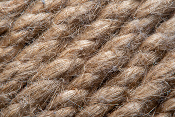 A background of roughly knitted fabric in soft focus under high magnification. Synthetic fabric stylized as an old, chunky-knit linen thread.