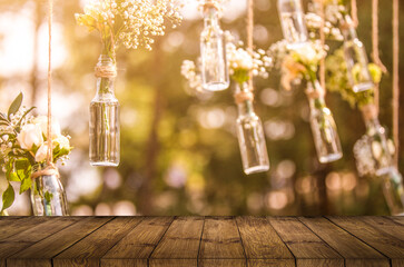 wooden table decor. The banquet area hang garlands of lights entwined with green plant. Wooden stand with lights and greenery. With the lights behind.