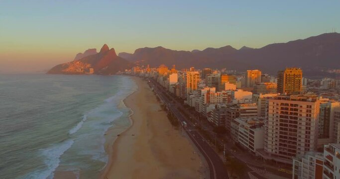 Rio de Janeiro sunrise past buildings on ipanema beach with mountains in the background