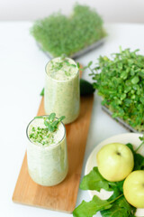 smoothie of micro-green apples cucumber and spinach on a light background. eco organic fresh food detox . ingredients fresh micro-greens . close-up selective focus