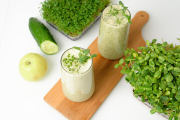 smoothie of micro-green apples cucumber and spinach on a light background. eco organic fresh food detox . ingredients fresh micro-greens . close-up selective focus