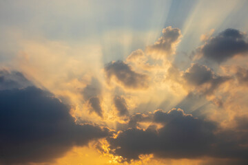Naklejka na ściany i meble Beautiful crepuscular sun ray shines through the cloud